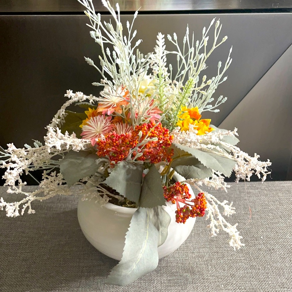 Dried faux flowers in white squat pot decor